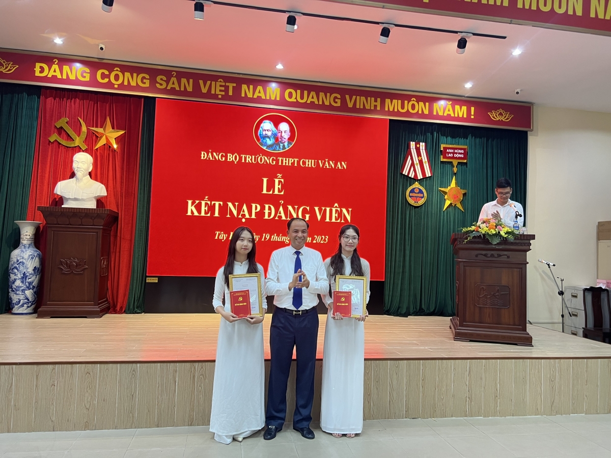 Đồng chí Nguyễn Đình Khuyến - Phó Bí thư Quận ủy, Chủ tịch UBND quận Tây Hồ trao quyết định kết nạp Đảng cho 2 tân đảng viên trẻ