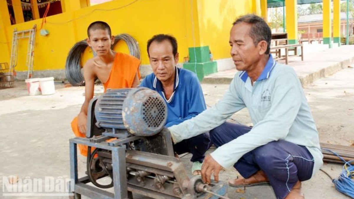 Ông Danh Hùng (ngoài cùng bên phải) cùng các thành viên trong đội thi công cắt sắt để xây cầu.