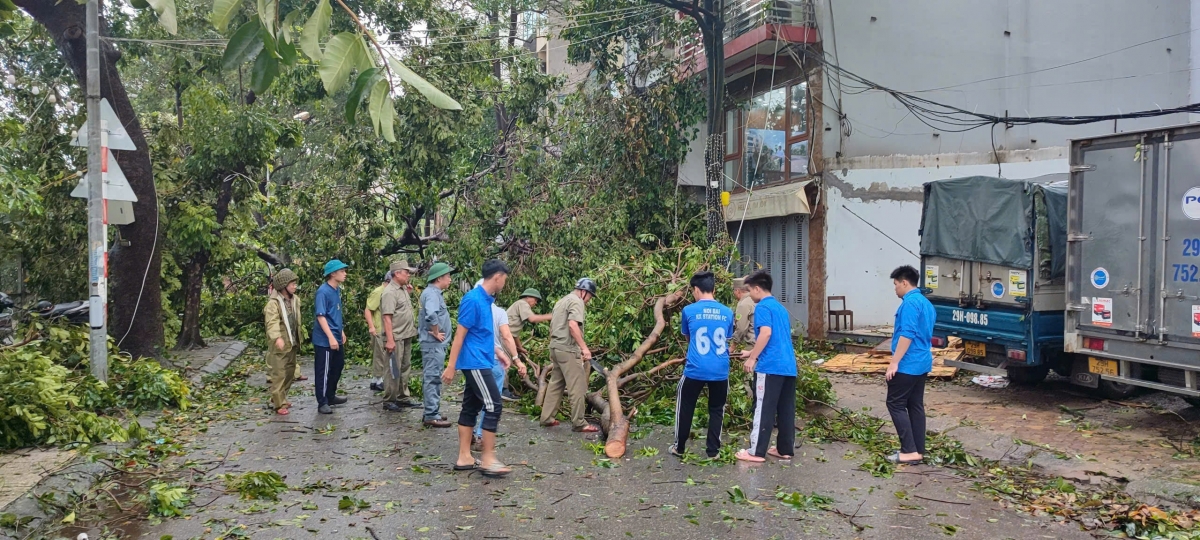 Đoàn viên thanh niên tham gia hỗ trợ dọn dẹp cây đổ.
