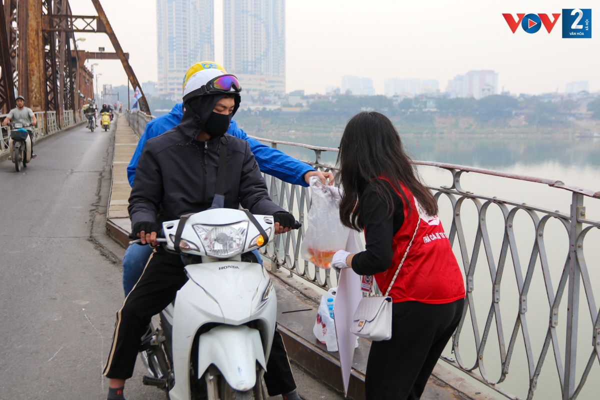 Nhiều người dân vui vẻ đưa cá cho đội tình nguyện viên hỗ trợ thả.